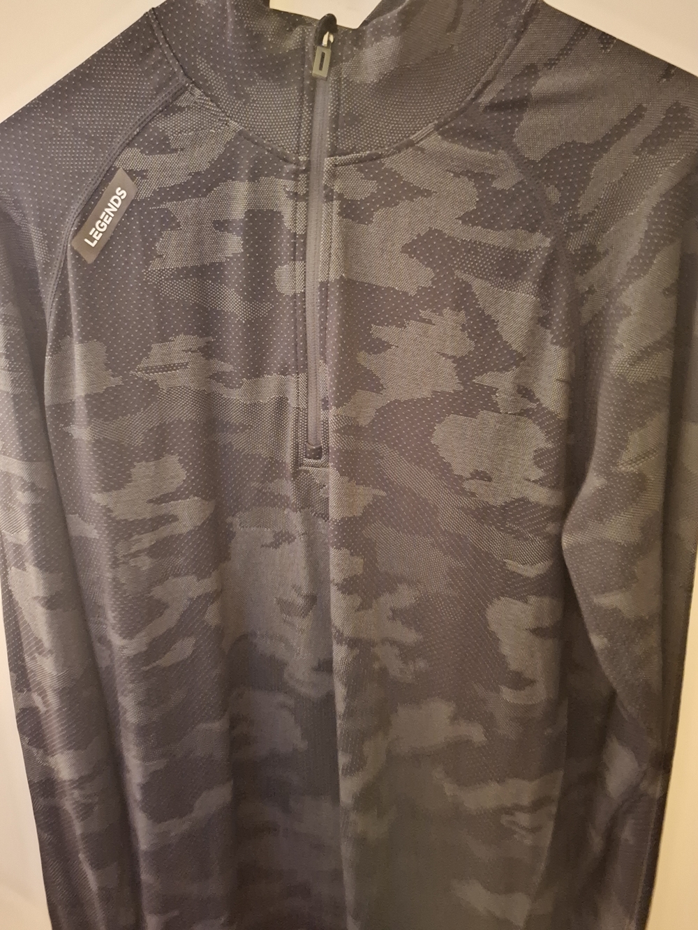 Legends Dash Quarter Zip in a black and gray camo